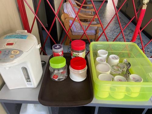 a lunch box and a toaster on a table at Tabin Lodge Budget Stay in Lahad Datu
