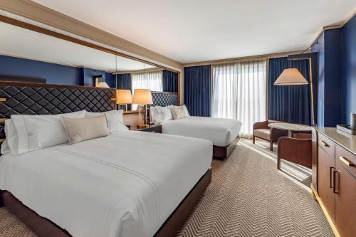 a hotel room with a large bed and a desk at Omni Oklahoma City Hotel in Oklahoma City
