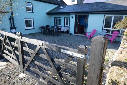 a wooden fence in front of a house at Newly renovated entire residential home Annestown Beach, County Waterford in Annestown