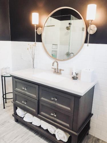 a bathroom with a sink and a mirror at Guesthouse on Girod in Mandeville