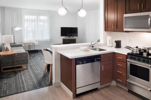 a kitchen with a sink and a stove at TownePlace Suites by Marriott Galveston Island in Galveston