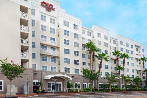 a large white building with palm trees in front of it at Residence Inn Tampa Downtown in Tampa