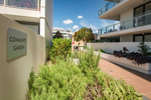 a building with a sign on the side of it at Sensational City Apartment with Lake Views in Canberra