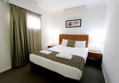 a hotel room with a bed and a window at Chinchilla Downtown Motor Inn in Chinchilla