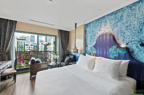 a hotel room with a bed and a balcony at 22Land Heritage Hotel & Retreat in Hanoi