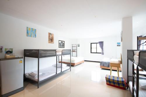 two bunk beds in a room with a room with two beds at Arttra Villa in Bang Chak