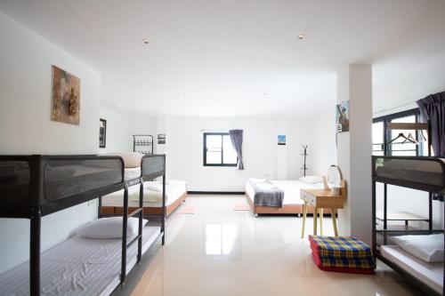 a room with bunk beds and a room with a desk at Arttra Villa in Bang Chak