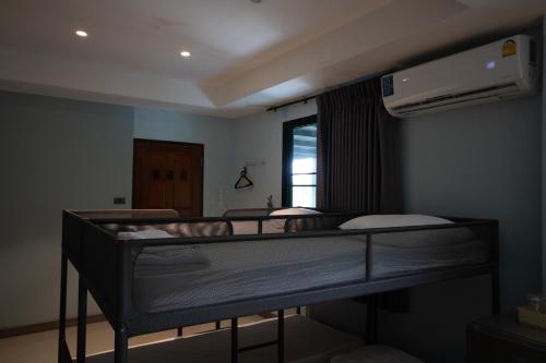 a room with two bunk beds and a window at Arttra Villa in Bang Chak