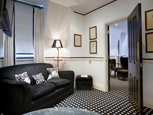 a living room with a couch and a room with a window at 41 in London
