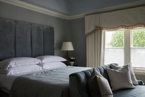 a bedroom with a large bed and a window at Egerton House in London