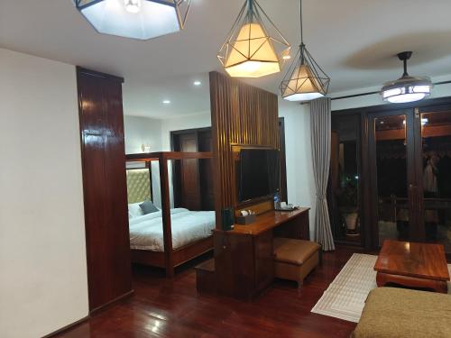 a bedroom with a bed and a tv in it at Happy hour boutiquehotel in Luang Prabang