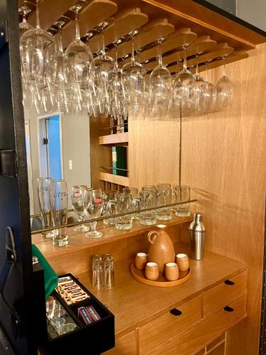 a room with many glasses on a shelf with a counter at Corazón de México in Mexico City