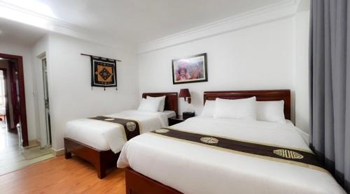 a hotel room with two beds in a room at Sapa Lake View Hotel in Sa Pa