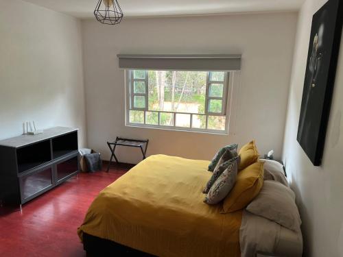 a bedroom with a bed and a window in it at Corazón de México in Mexico City
