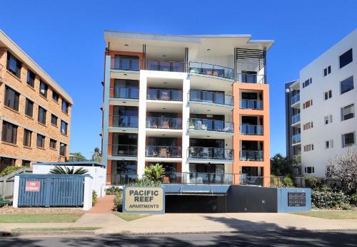 an apartment building with a parking meter sign in front of it at 501 Pacific Reef in Bargara