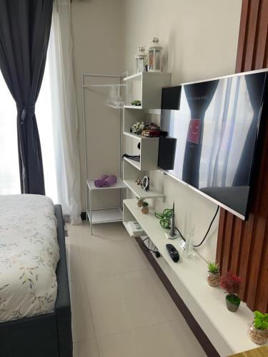 a bedroom with a desk with a flat screen tv at L L I Condotel in Lapu Lapu City