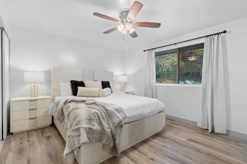 a white bedroom with a bed and a ceiling fan at Ski Lover's Paradise- 7BR Villa Near Top Resorts home in Holladay