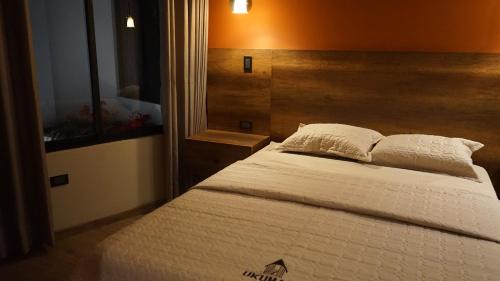 Ένα ή περισσότερα κρεβάτια σε δωμάτιο στο Ukumari Hotel
