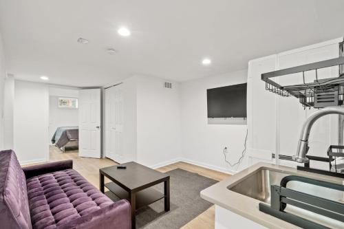 a living room with a couch and a sink at Negin 2903 - Basement Unit in Washington, D.C.