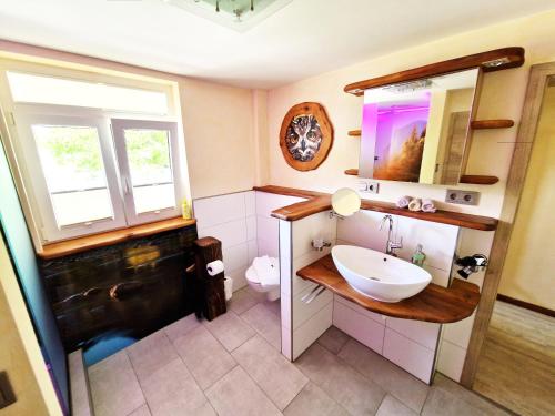 a bathroom with a sink and a toilet at Landgasthof Rebstock in Ottenhöfen