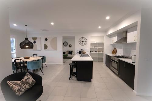 a kitchen and dining room with a table in it at Brand new 4 bedroom home with Golf Views in Yarrawonga