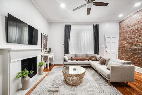 a living room with a couch and a fireplace at Urban Oasis Haven in St Catherine in Louisville