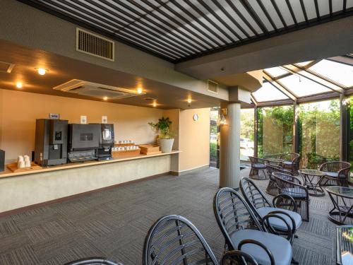 a patio with chairs and a counter with a kitchen at KAMENOI HOTEL Nachi Katsuura Kumano Kodo in Nachikatsuura