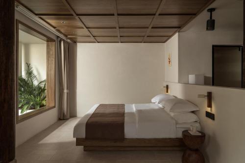 Postel nebo postele na pokoji v ubytování Shijing Hotel in Dali-大理柿井美宿