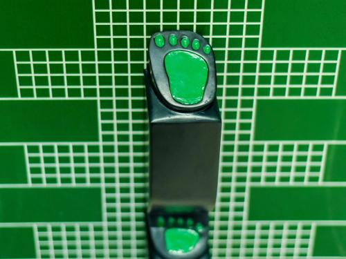 a remote control sitting on top of a green tiled wall at 秋果酒店-重庆两江幸福广场店 in Chongqing