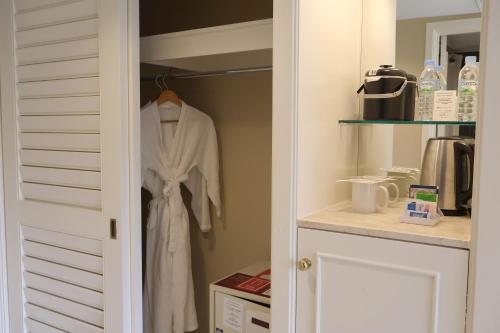 a white robe is hanging in a closet at Hilton Guam Resort & Spa in Tumon