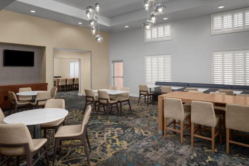 a large room with tables and chairs and a tv at Residence Inn by Marriott Santa Clarita Valencia in Santa Clarita