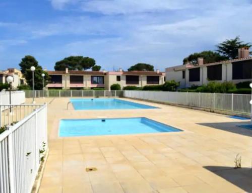 une piscine dans une cour clôturée dans l'établissement Appartement résidentiel, à Plage dʼArgelès