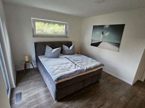 a bedroom with a bed with a picture of a lighthouse at Ferienwohnung Auszeit in Solnhofen