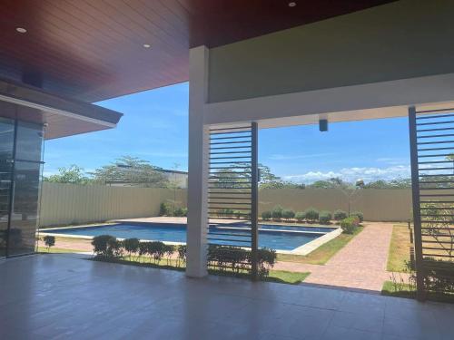 a view of a swimming pool from the inside of a house at KaribuBnb in Lapu Lapu City