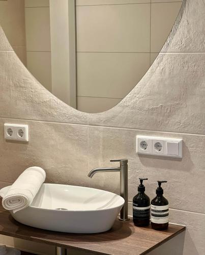 a bathroom with a sink and a mirror at Juliette Domburg in Domburg