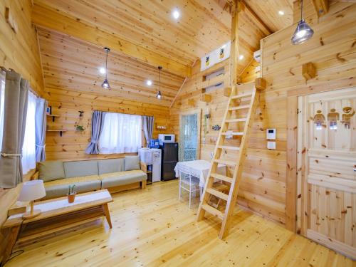 a log cabin living room with a ladder at UMIOTO log in Higa