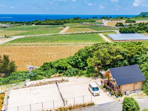 an aerial view of a farm with a van parked in front of a building at UMIOTO log in Higa