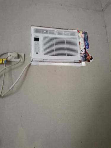 a air conditioner on a wall in a room at 1 Bed House - Sleeps 2 - Parking - Wifi in Zamboanga