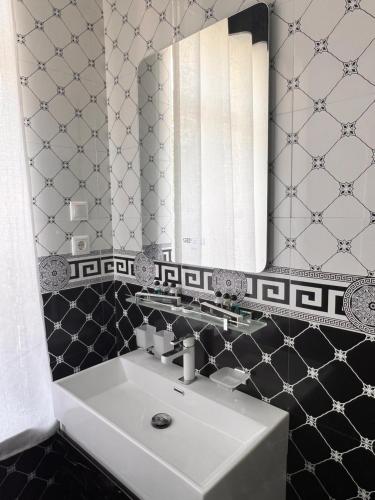 a bathroom with a sink and a mirror at Anor in Tashkent