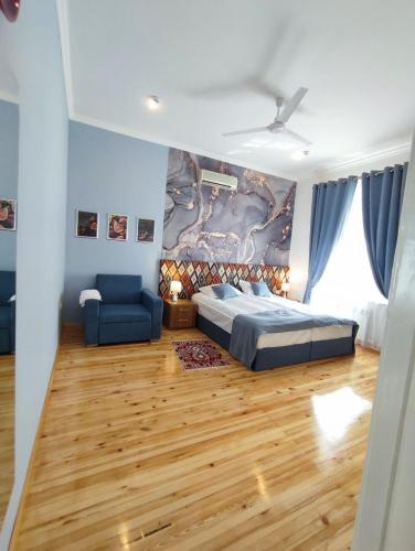 a bedroom with a bed and a blue couch at Anor in Tashkent