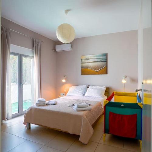 a bedroom with a large bed with towels on it at Villa SteMMa in Chania Town