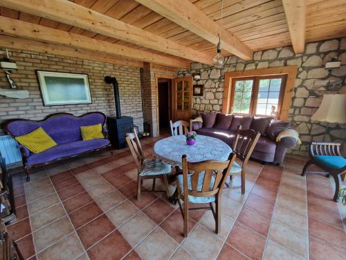 a living room with a table and a couch at Harcówka in Miękisz Nowy