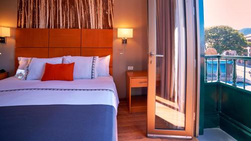 a hotel room with a bed and a window at Xima Exclusive Cusco in Cusco