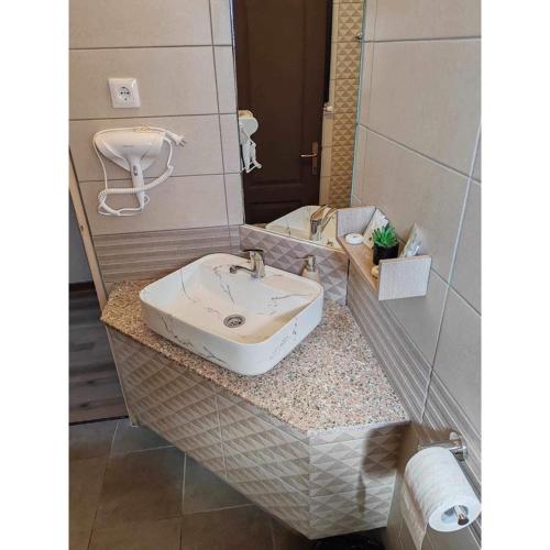 a bathroom with a sink and a mirror at Vila Maya in Băile Tuşnad