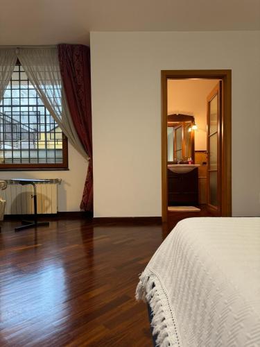 a bedroom with a bed and a large window at Giardini Normanni in Aversa