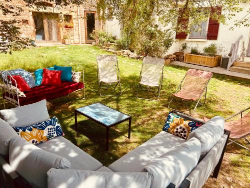 a group of chairs and couches in a yard at Pannonica charmante maison champêtre in Montagny-sur-Grosne