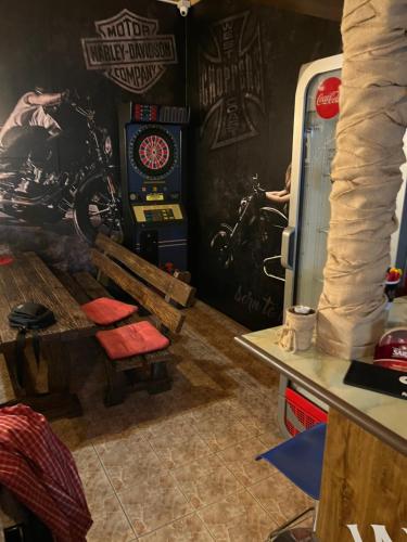 a room with a poker machine and a table at Penzión Šírava in Kaluža