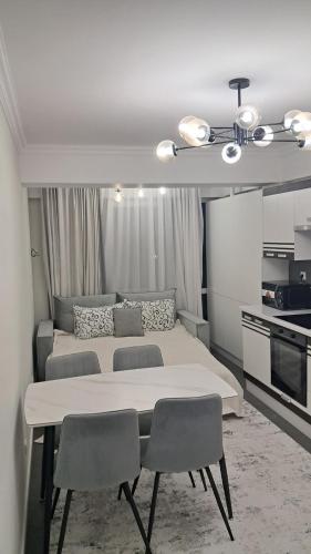 ein Schlafzimmer mit einem großen Bett und zwei Stühlen in der Unterkunft Уютный Дом in Chişinău