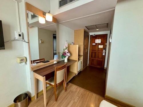 a small room with a table and a refrigerator at Aloha Hatyai Hotel in Hat Yai