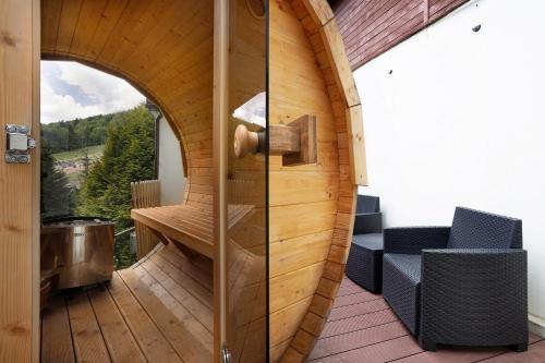 a circular room with a glass door on a deck at Hotel Pegaz in Krynica Zdrój